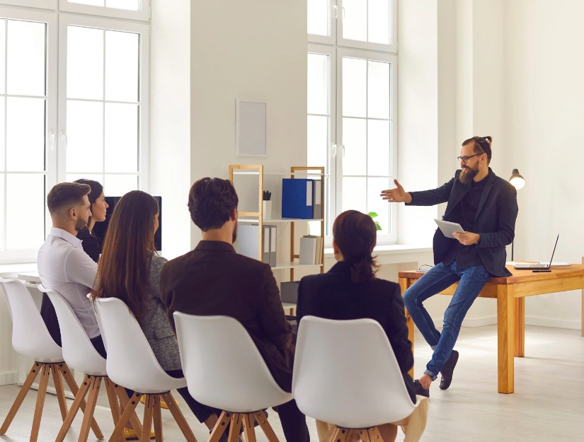 A man presenting Infront of a group of people
