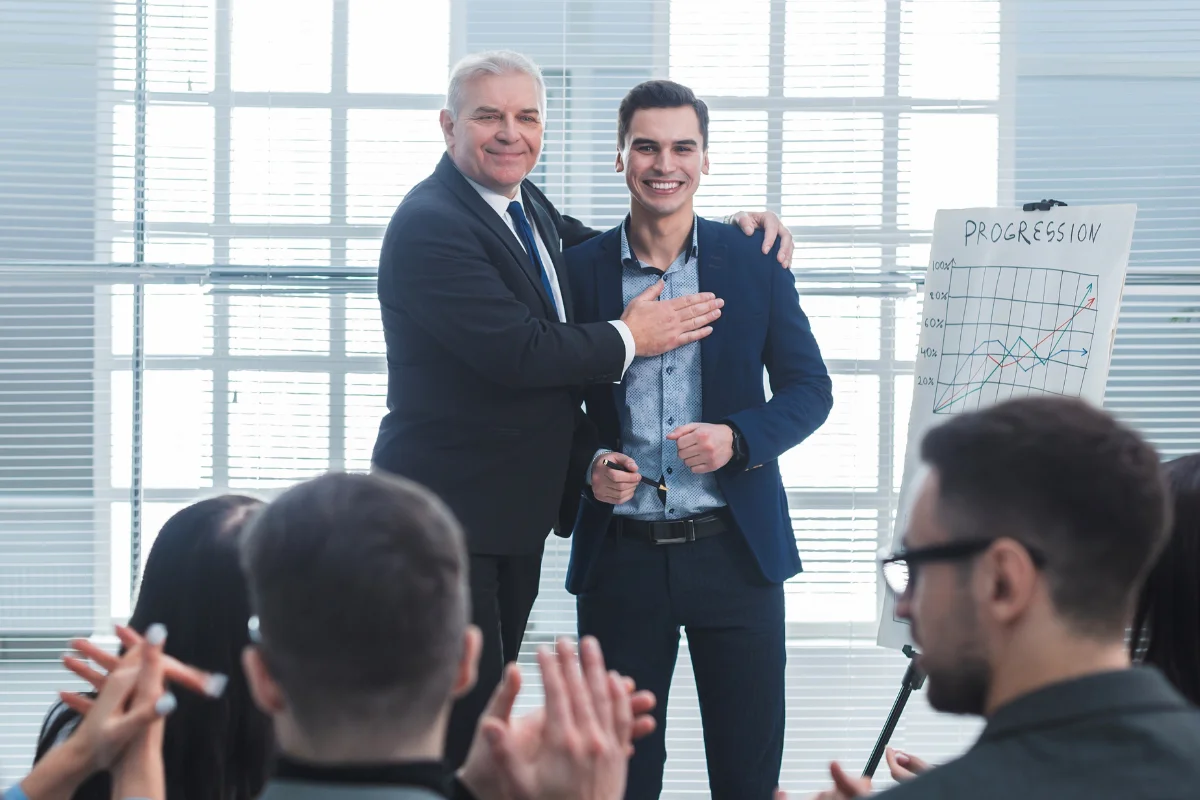 Businessman congratulating a colleague during a presentation