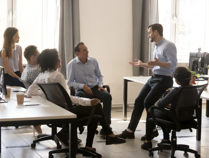 People listening to someone speaking in an office setting